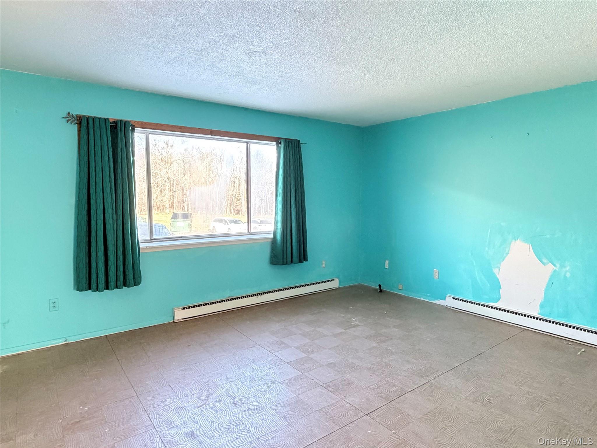 881 Albany Post Road, Unit 21 New Paltz, NY 12561 - Photo 7 of 19 an empty room with windows