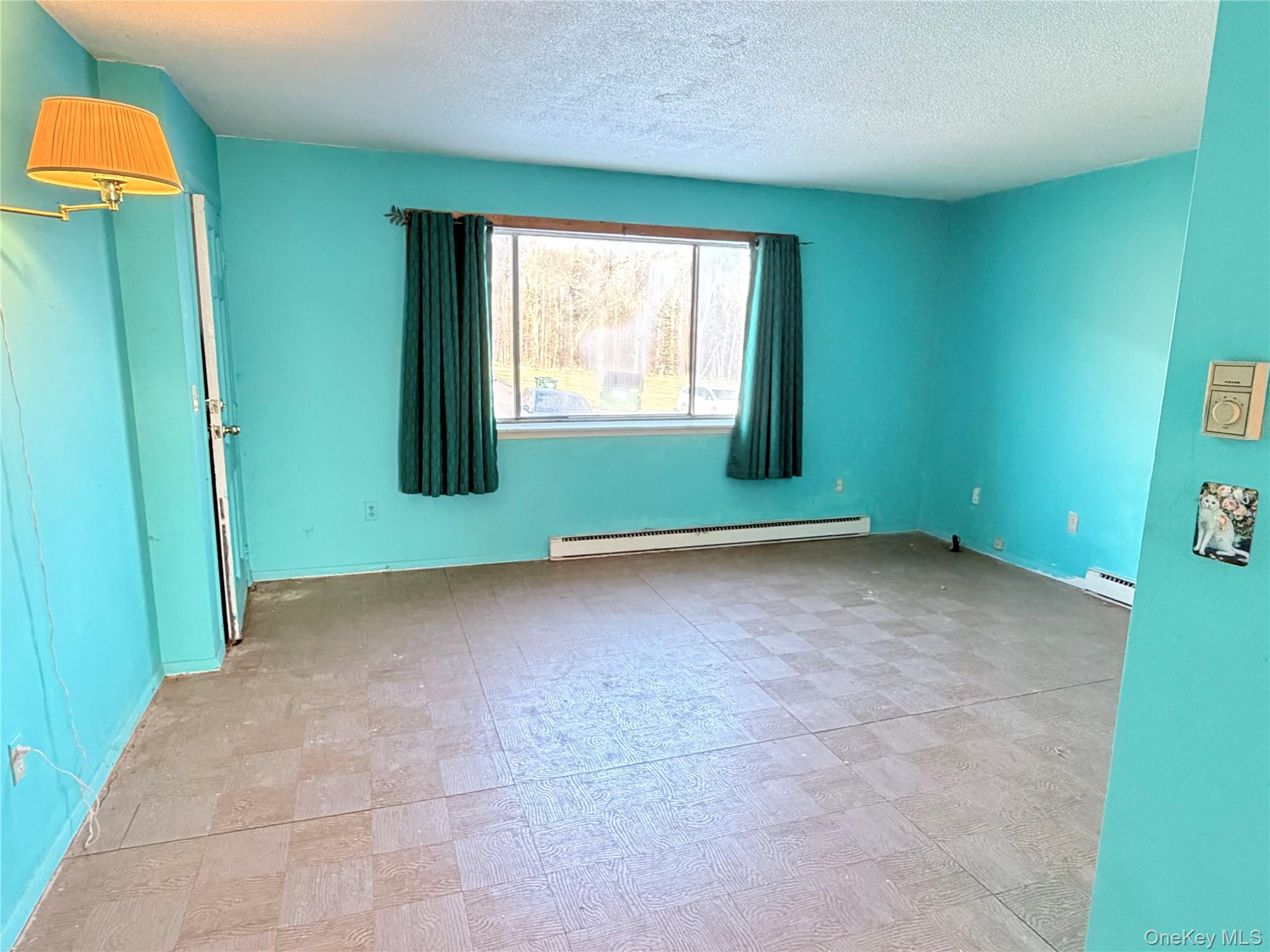 881 Albany Post Road, Unit 21 New Paltz, NY 12561 - Photo 8 of 19 an empty room with windows and entrance