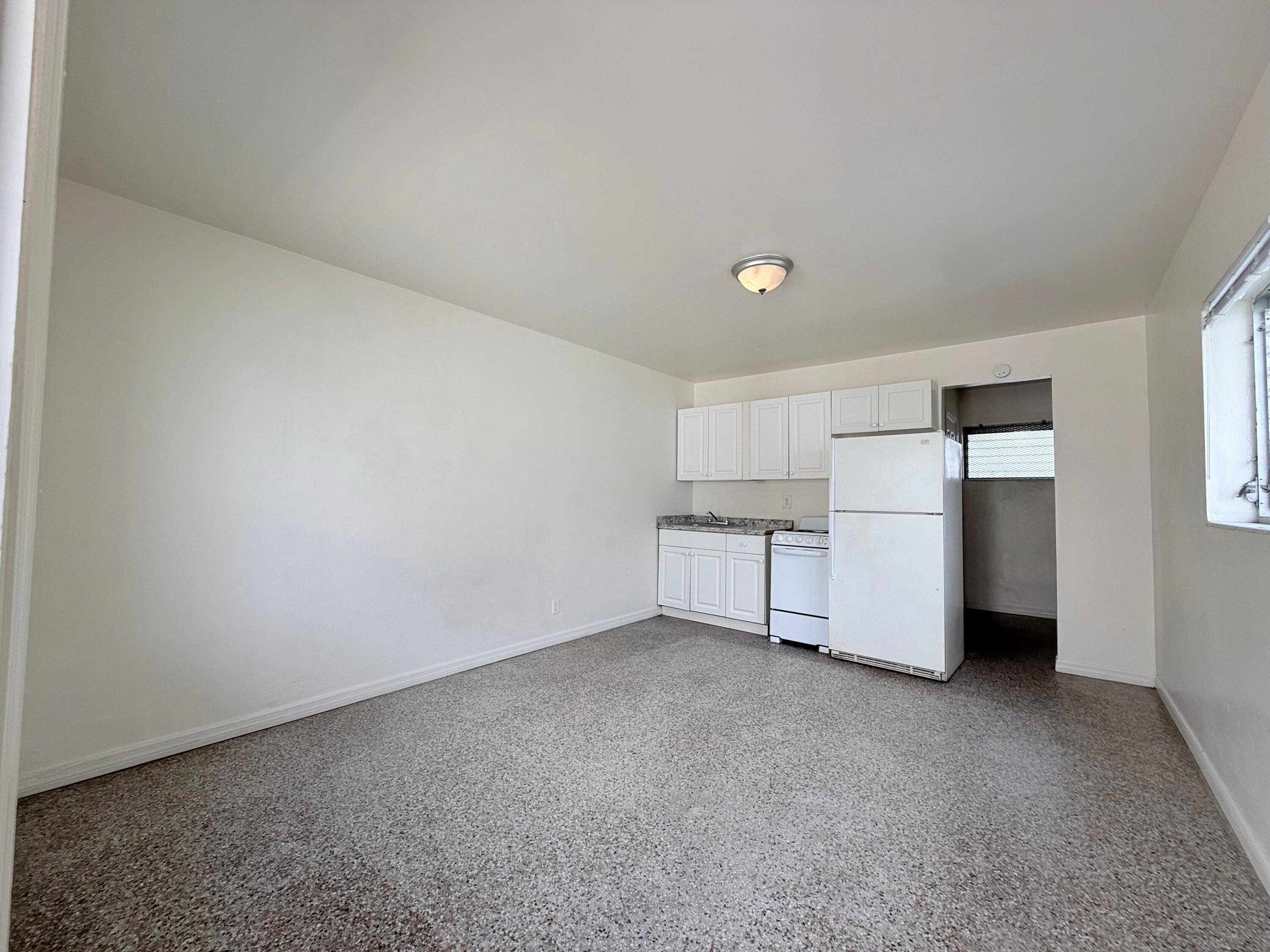 43 East 16th Street, Unit 4 Riviera Beach, FL 33404 - Photo 3 of 7 a view of an empty room with closet and a window