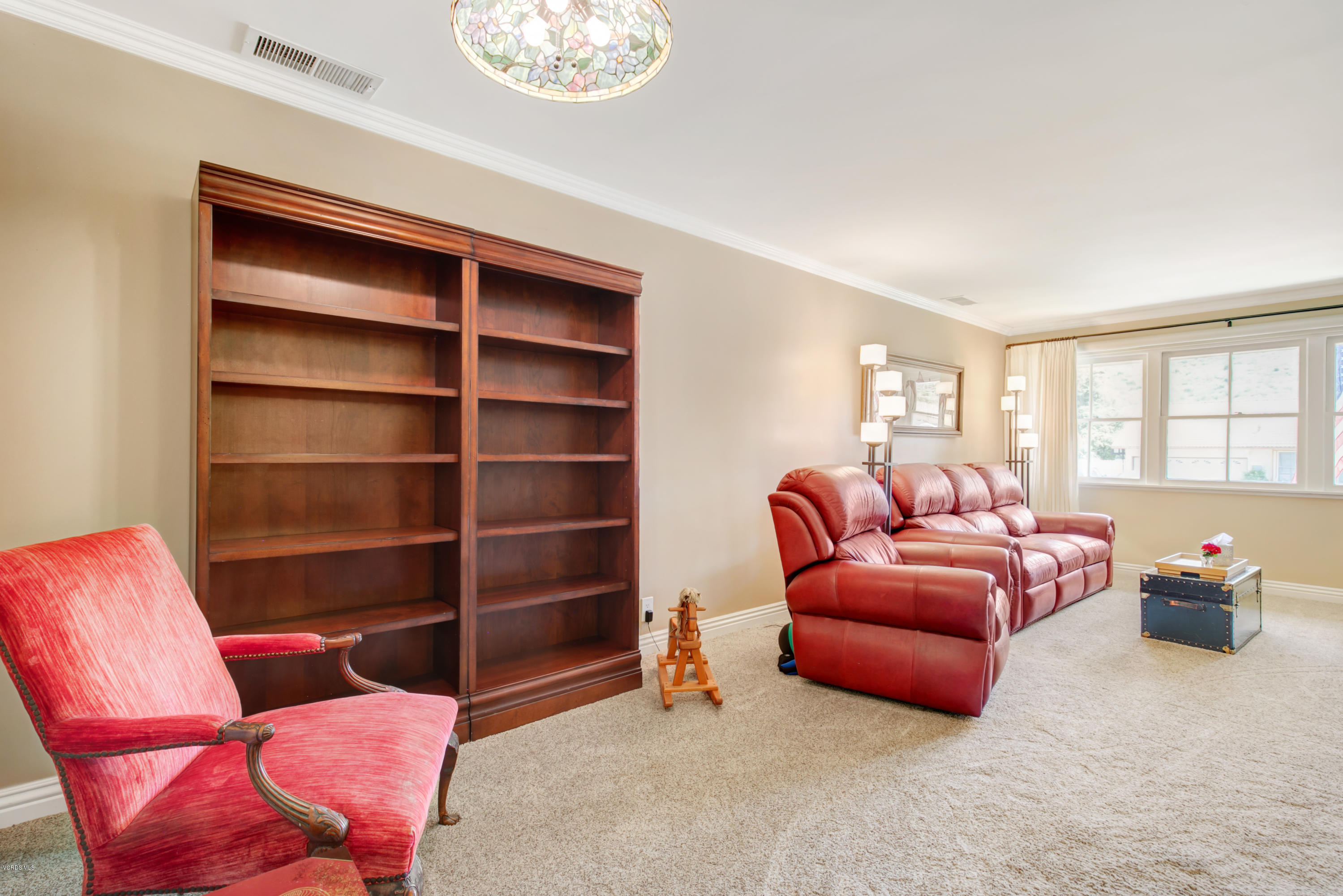 1291 Rambling Road Simi Valley, CA 93065 - Photo 16 of 75 a living room with furniture a ceiling fan and a window