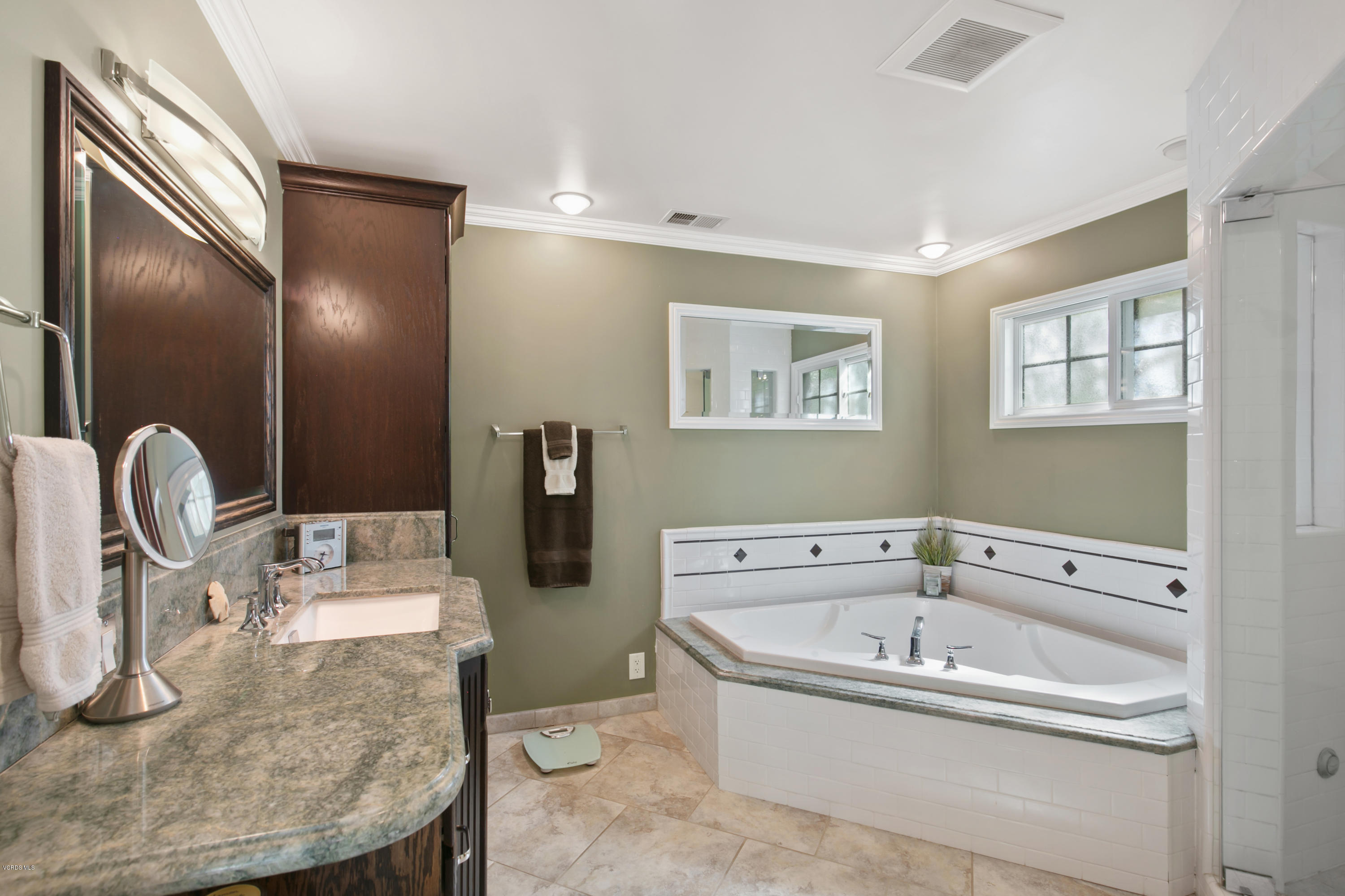1291 Rambling Road Simi Valley, CA 93065 - Photo 30 of 75 a bathroom with a tub sink and mirror