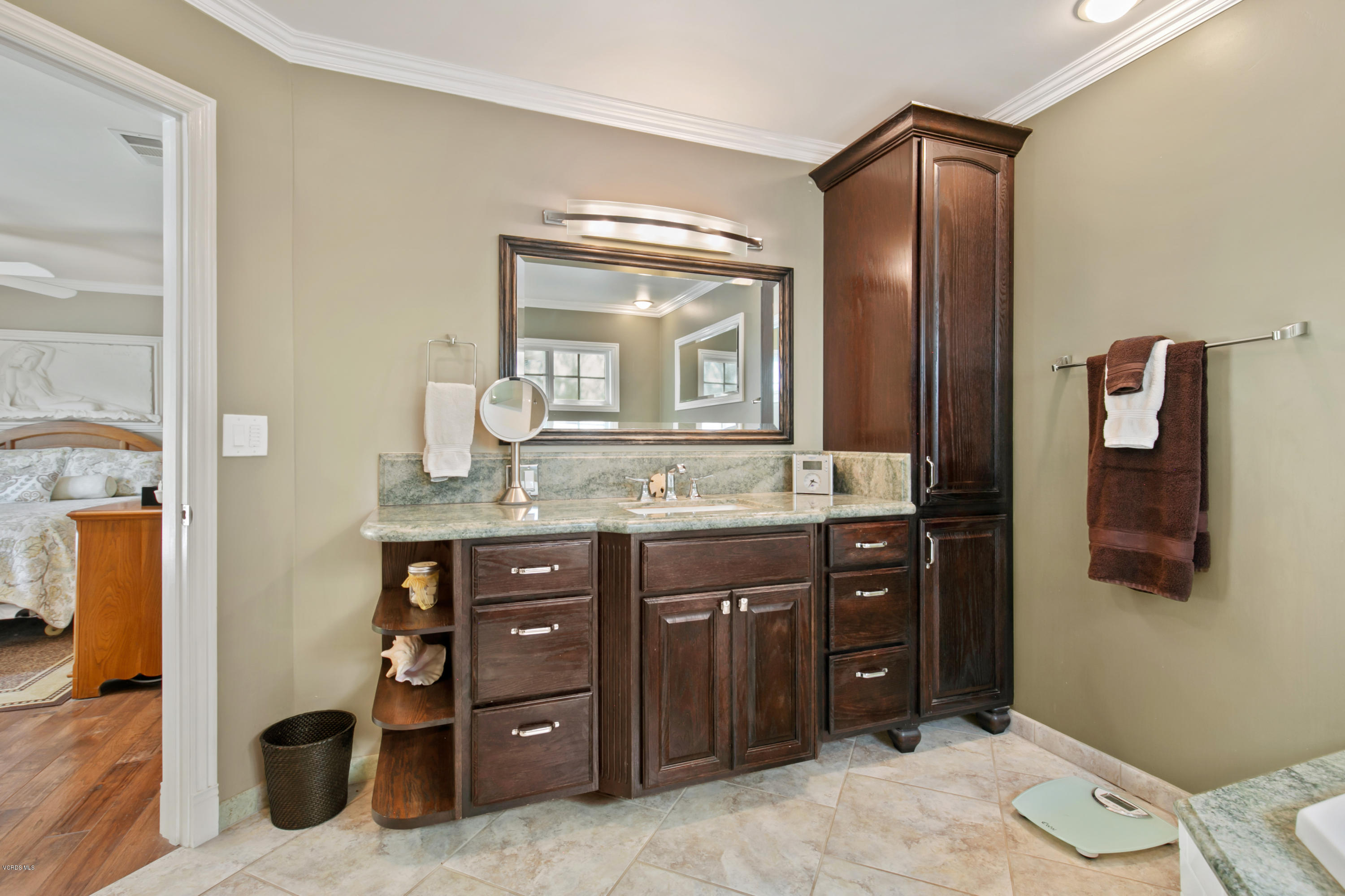1291 Rambling Road Simi Valley, CA 93065 - Photo 32 of 75 a spacious bathroom with a granite countertop sink and a mirror