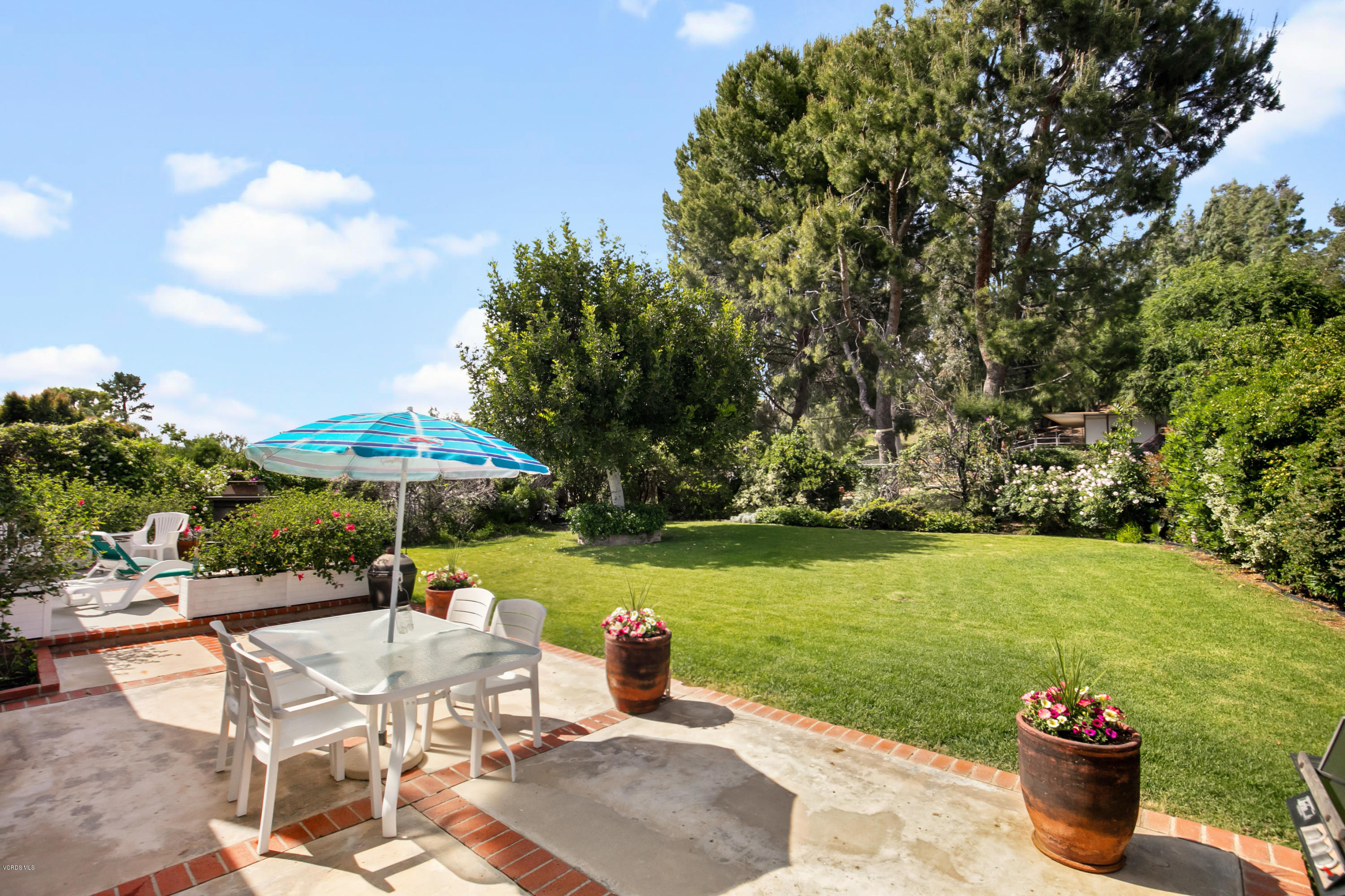 1291 Rambling Road Simi Valley, CA 93065 - Photo 33 of 75 a view of a patio with a table and chairs under an umbrella