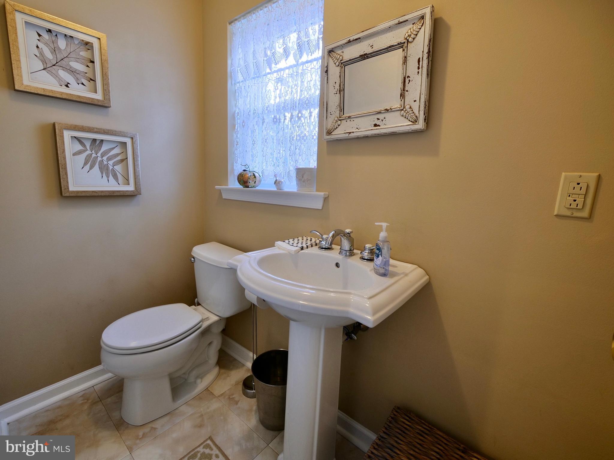 600 West Springfield Road Springfield, PA 19064 - Photo 7 of 28 a bathroom with a toilet sink and mirror
