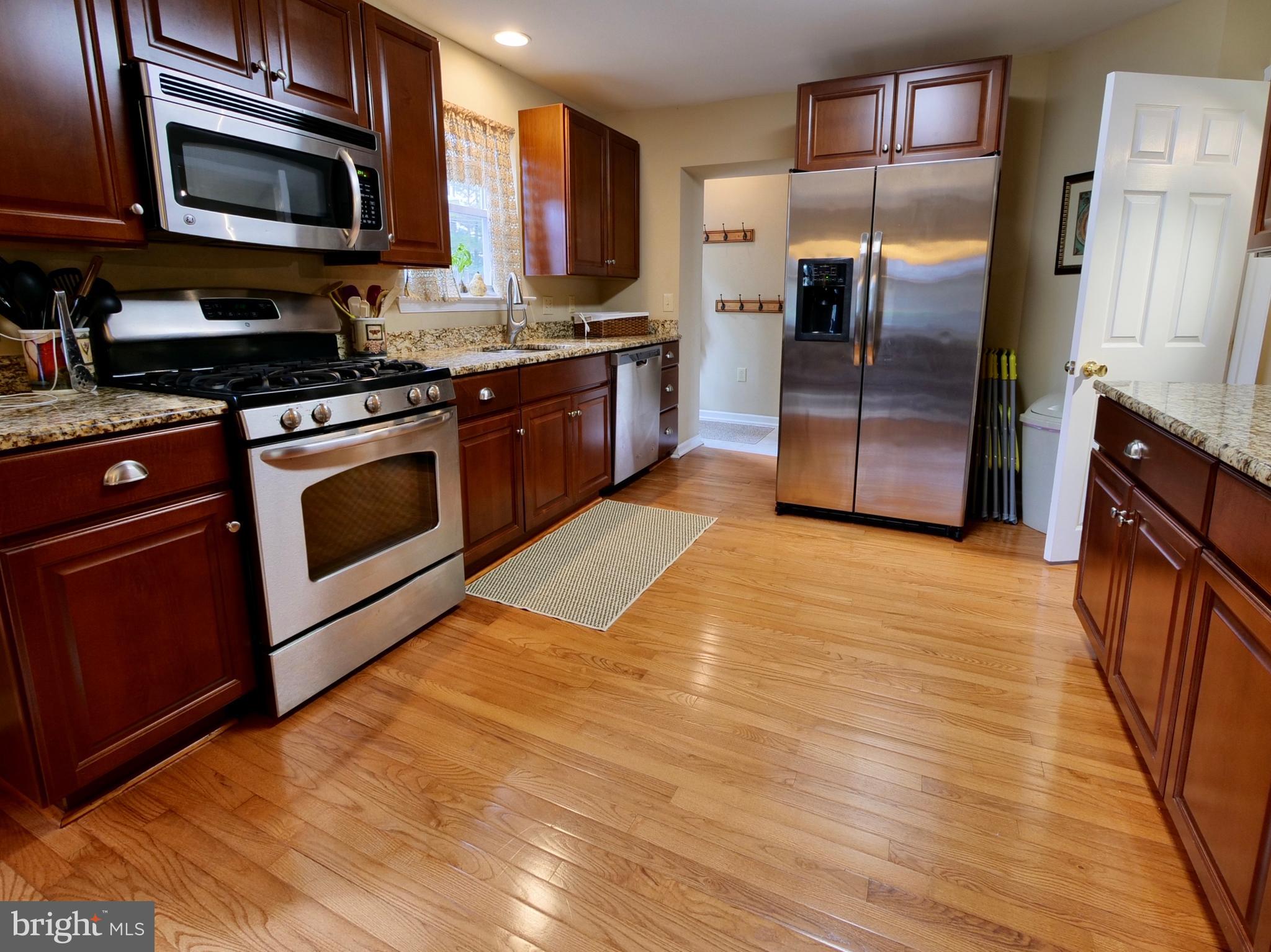 600 West Springfield Road Springfield, PA 19064 - Photo 8 of 28 a kitchen with stainless steel appliances granite countertop a stove a refrigerator and a microwave