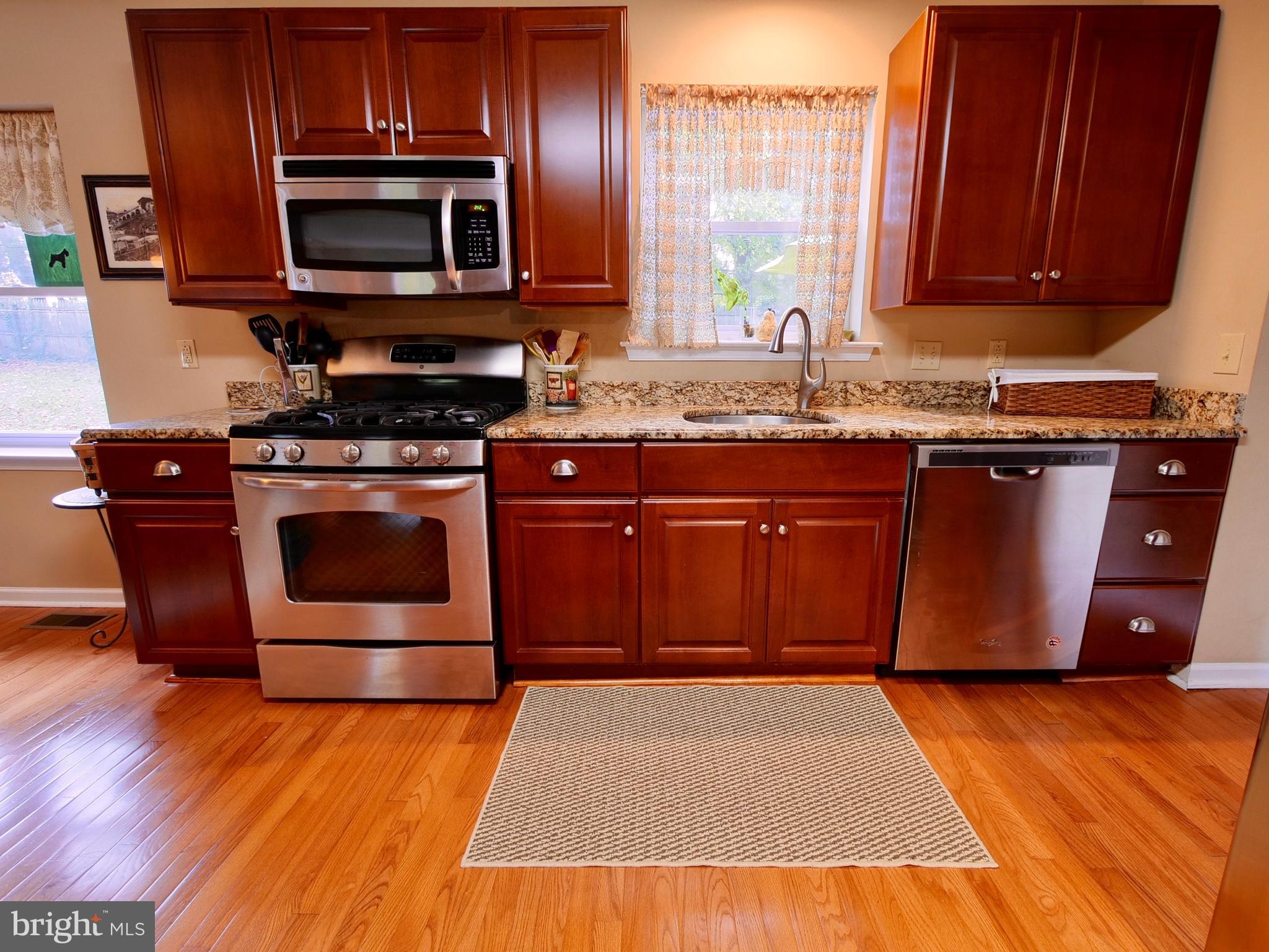 600 West Springfield Road Springfield, PA 19064 - Photo 9 of 28 a kitchen with stainless steel appliances granite countertop a stove a microwave and a sink
