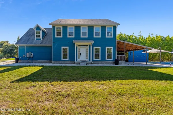 a front view of a house with a yard