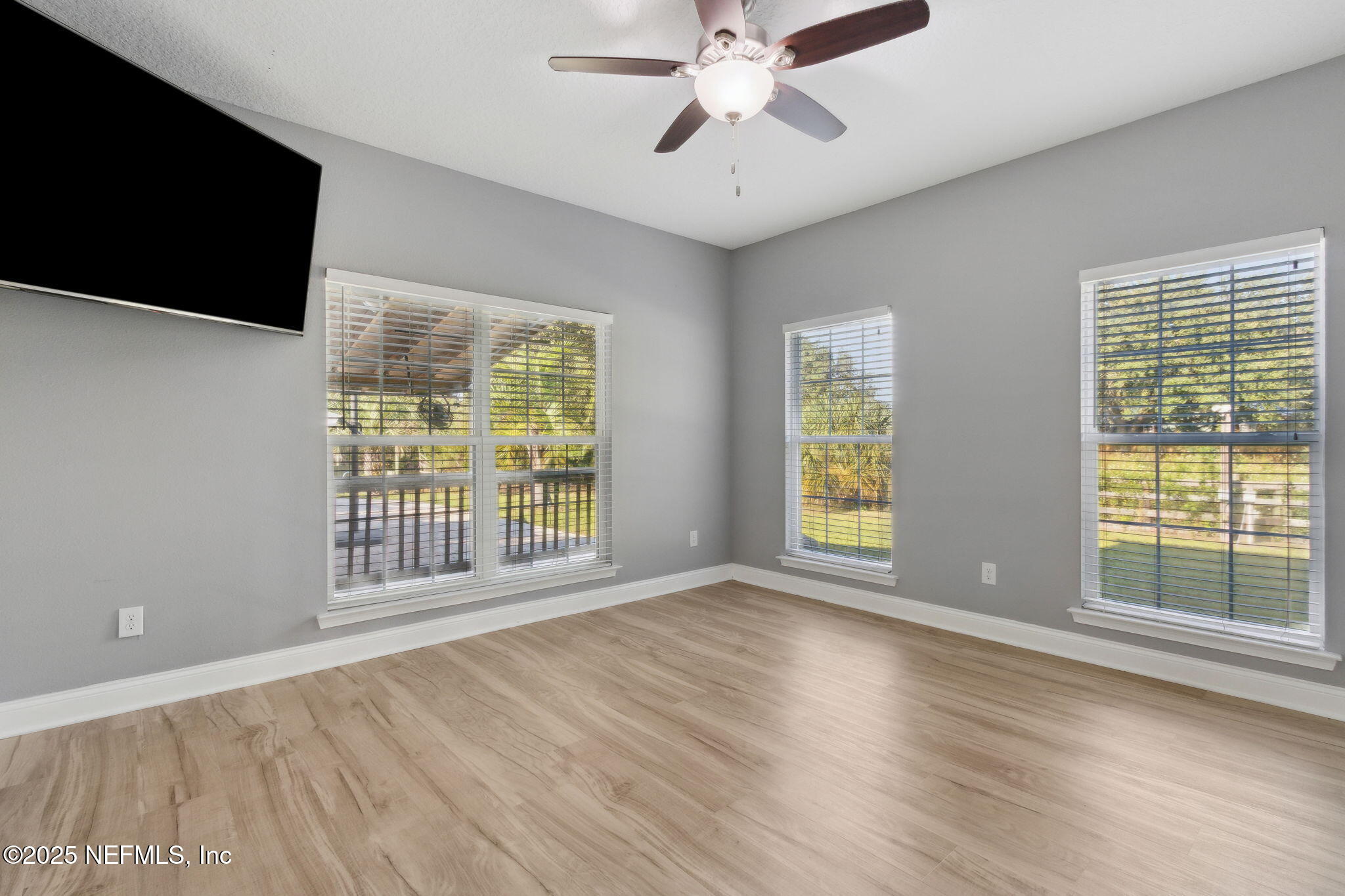 16199 Shellcracker Road Jacksonville, FL 32226 - Photo 13 of 40 a view of an empty room with wooden floor and a window