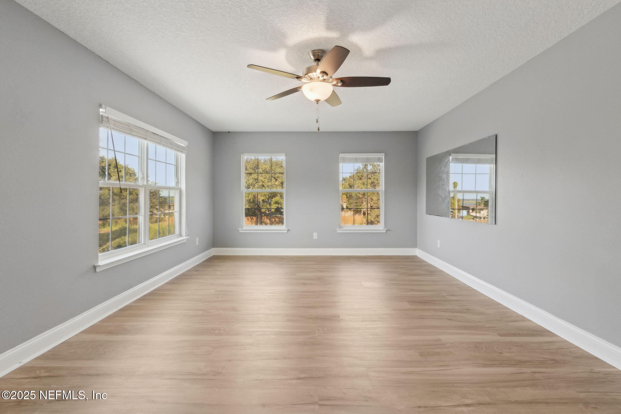 16199 Shellcracker Road Jacksonville, FL 32226 - Photo 14 of 40 a view of an empty room with wooden floor and a window