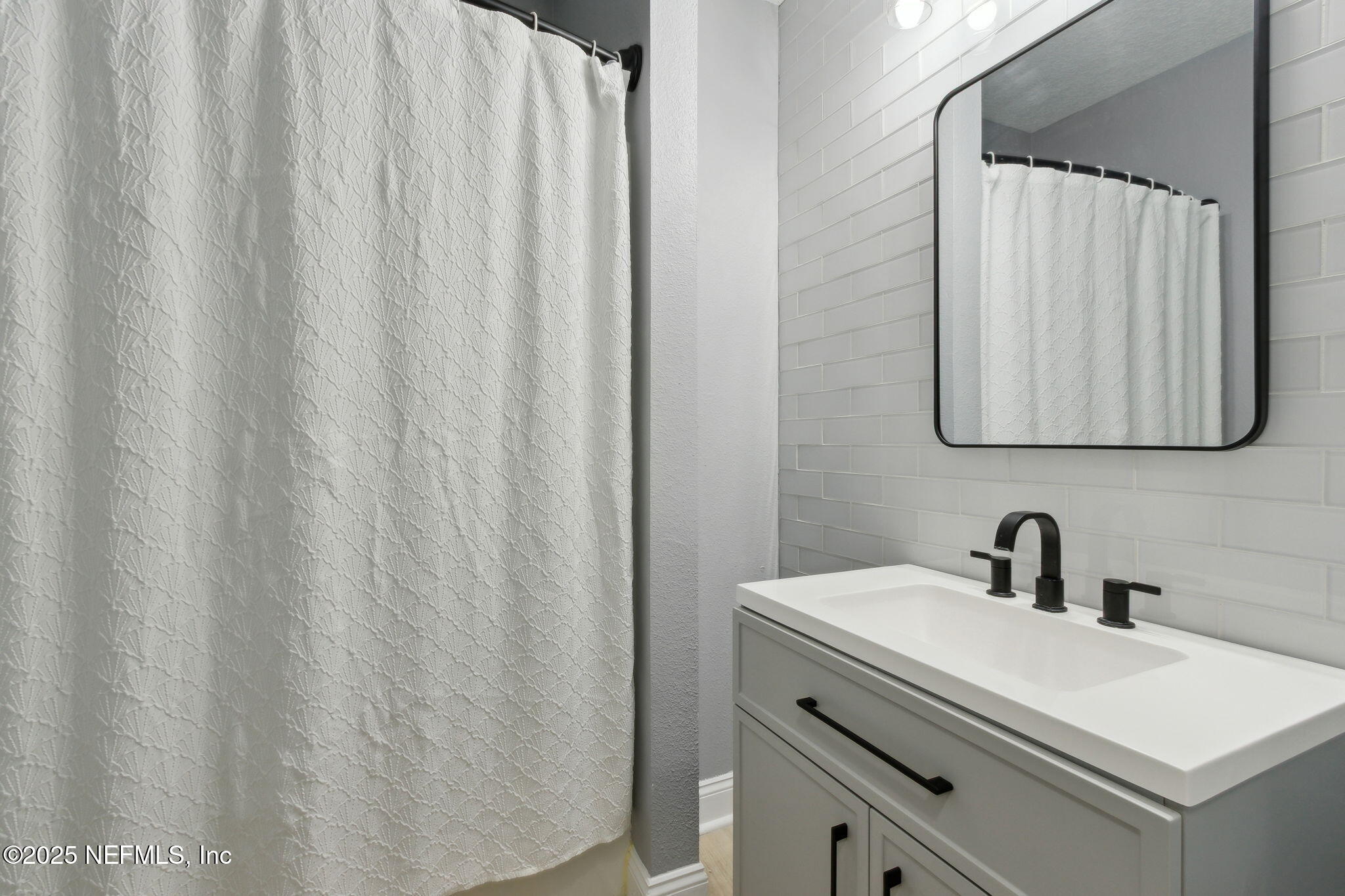 16199 Shellcracker Road Jacksonville, FL 32226 - Photo 14 of 40 a bathroom with a sink and a mirror