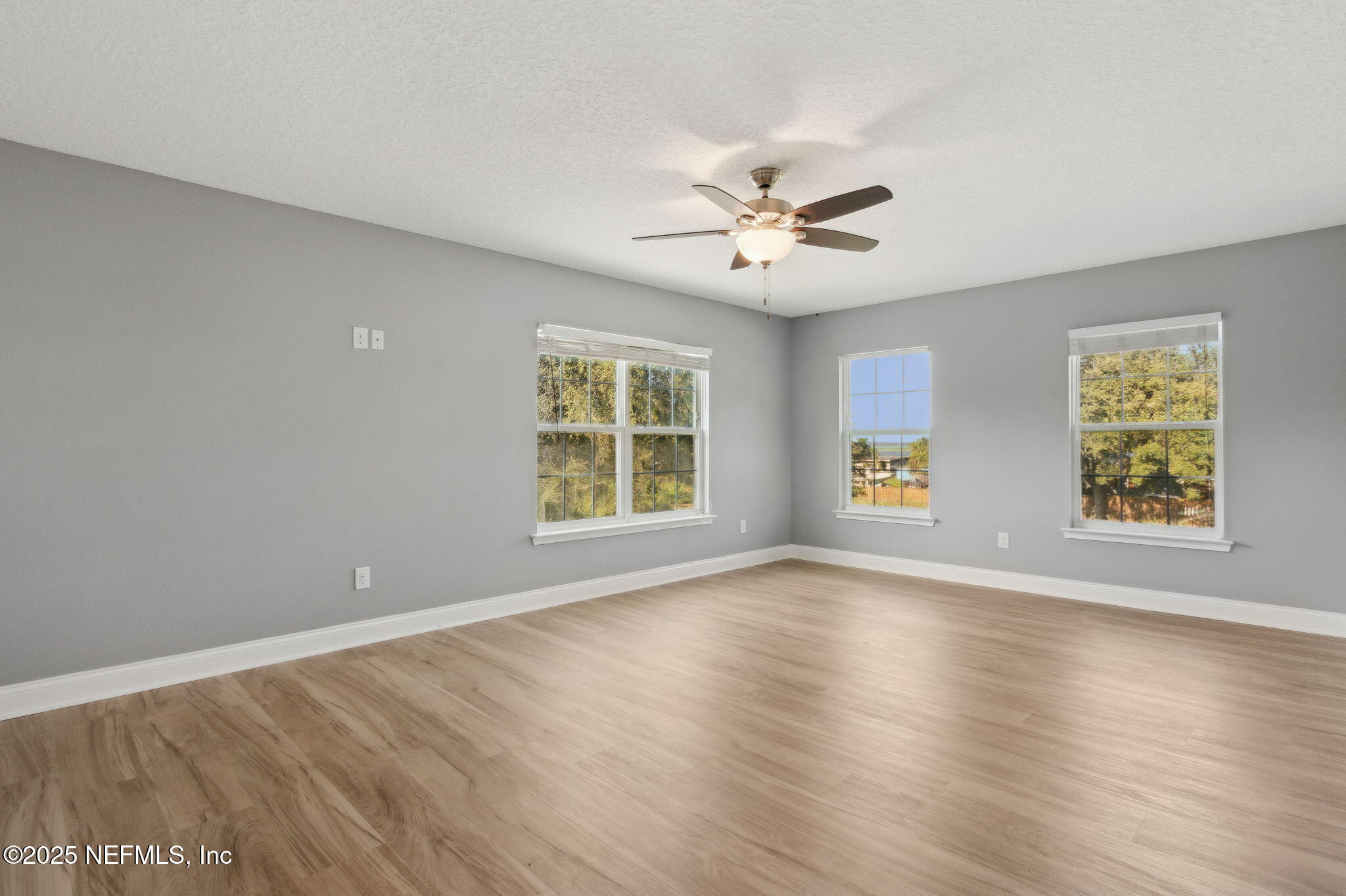 16199 Shellcracker Road Jacksonville, FL 32226 - Photo 15 of 40 a view of an empty room with a window and wooden floor