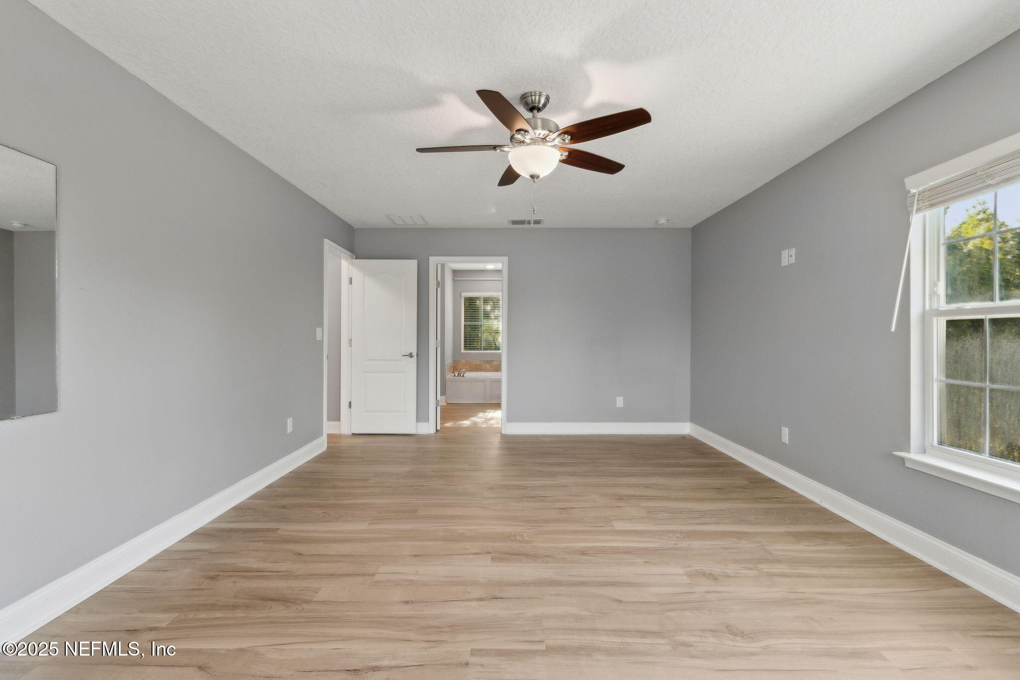 16199 Shellcracker Road Jacksonville, FL 32226 - Photo 16 of 40 a view of an empty room with wooden floor and a window