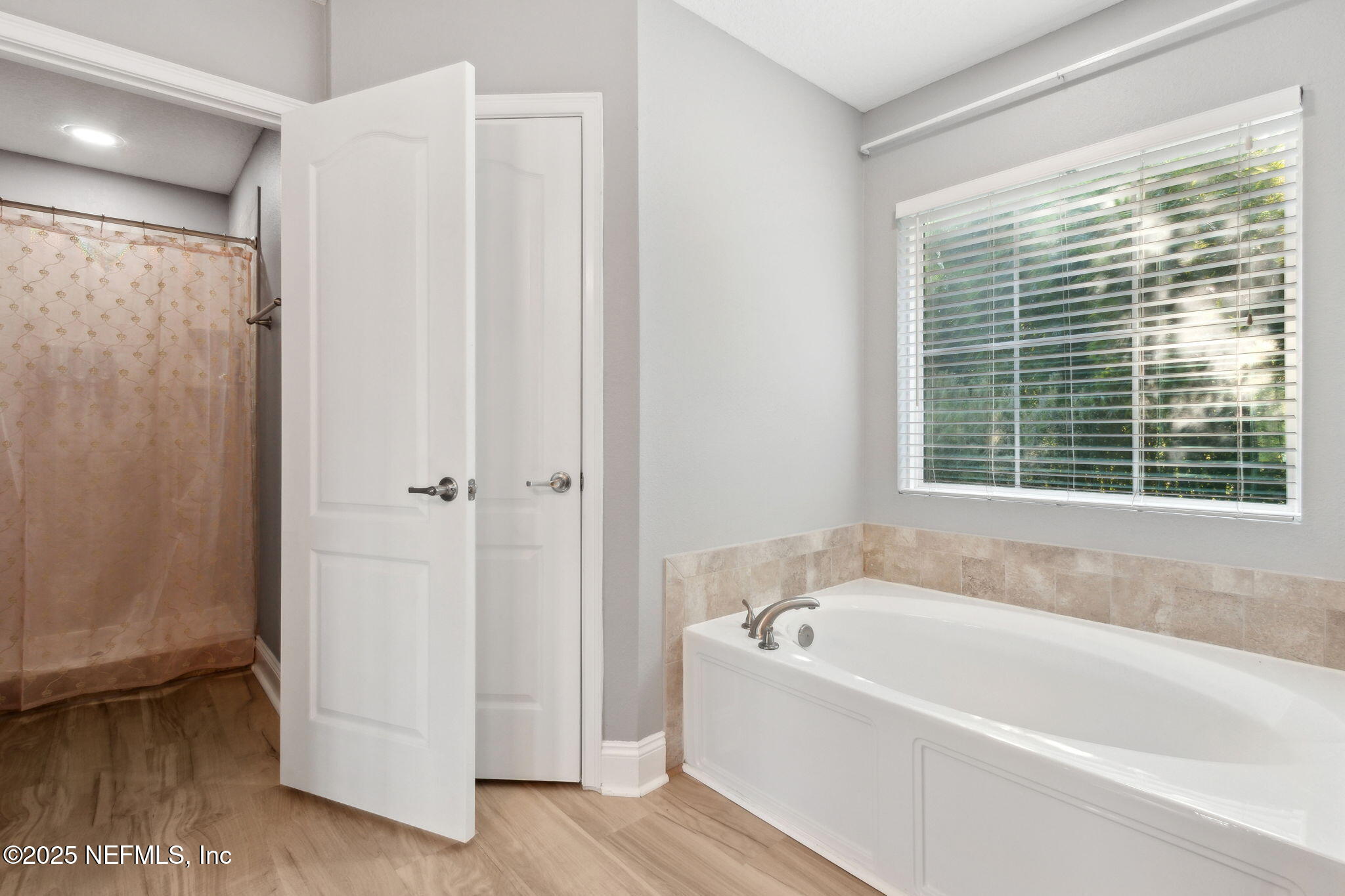 16199 Shellcracker Road Jacksonville, FL 32226 - Photo 19 of 40 a white bath tub sitting next to a window