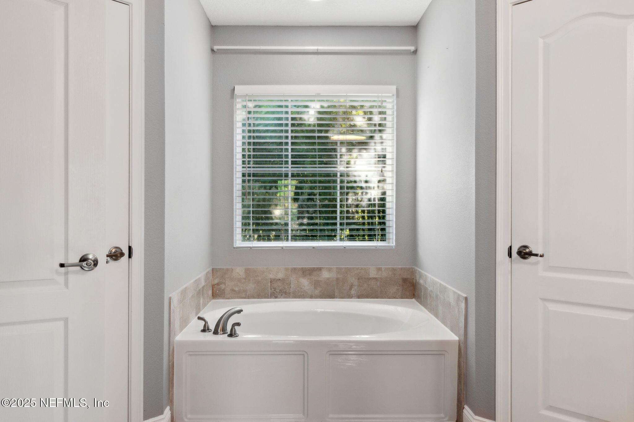 16199 Shellcracker Road Jacksonville, FL 32226 - Photo 20 of 40 a bathroom with a bathtub window and shower