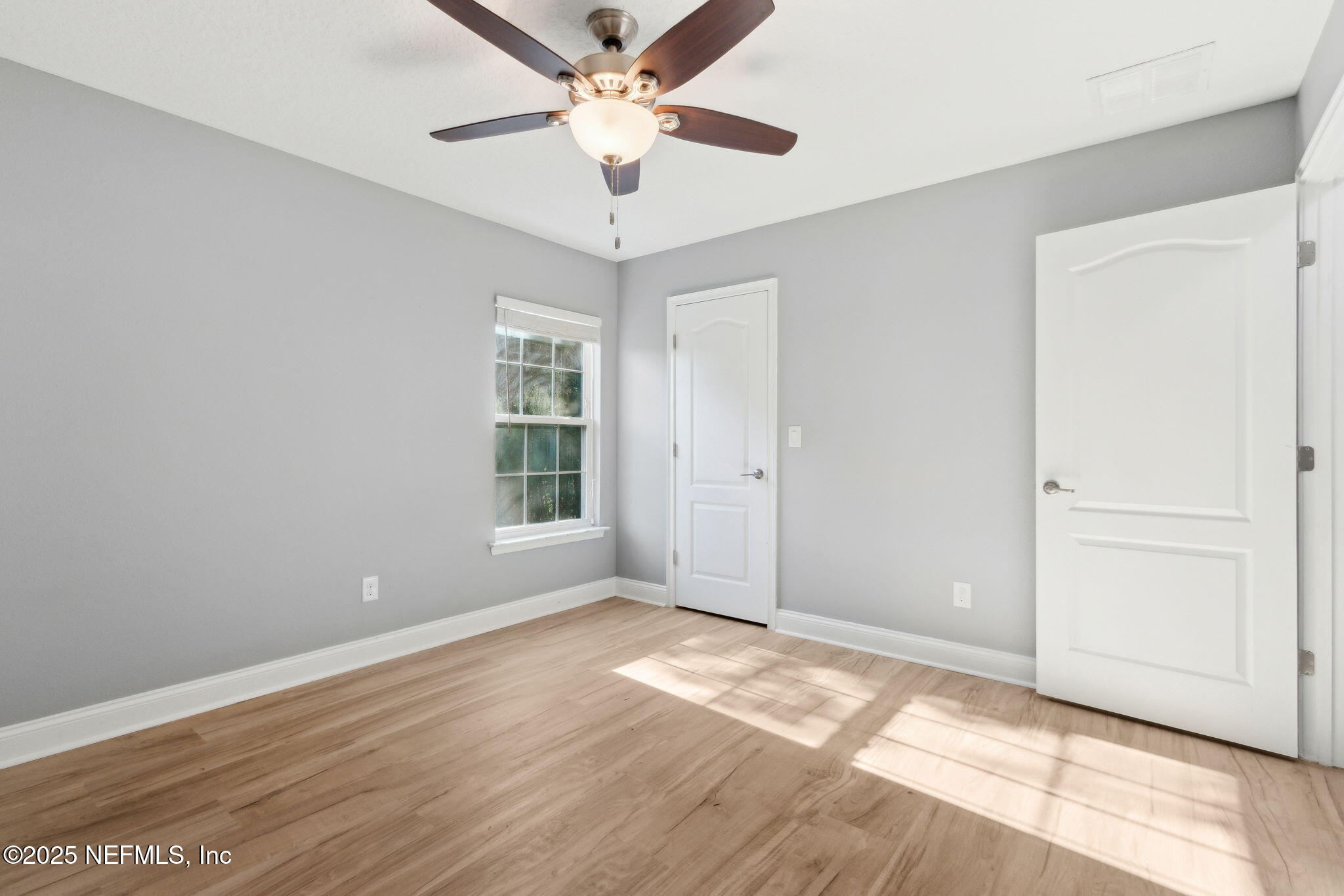 16199 Shellcracker Road Jacksonville, FL 32226 - Photo 23 of 40 wooden floor in an empty room with a window