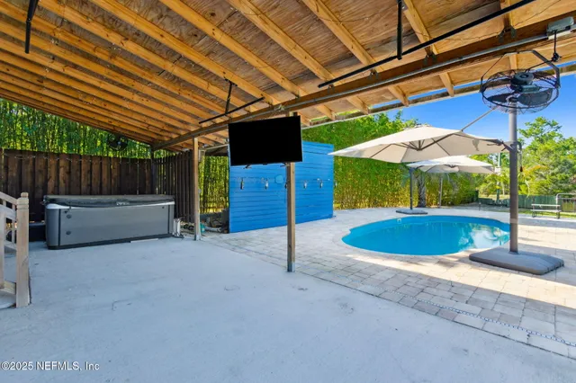 a view of a swimming pool with a bench in the patio