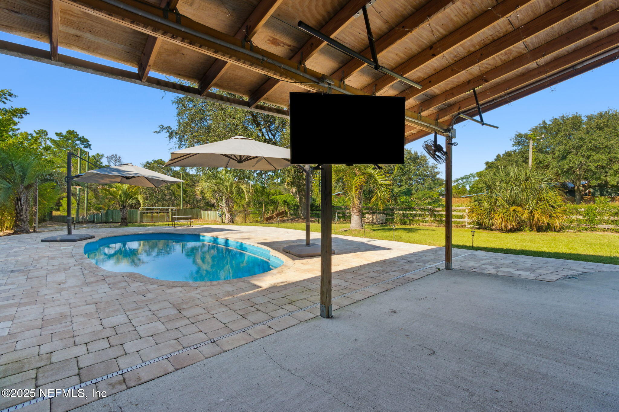 16199 Shellcracker Road Jacksonville, FL 32226 - Photo 4 of 40 a view of a swimming pools under an umbrella