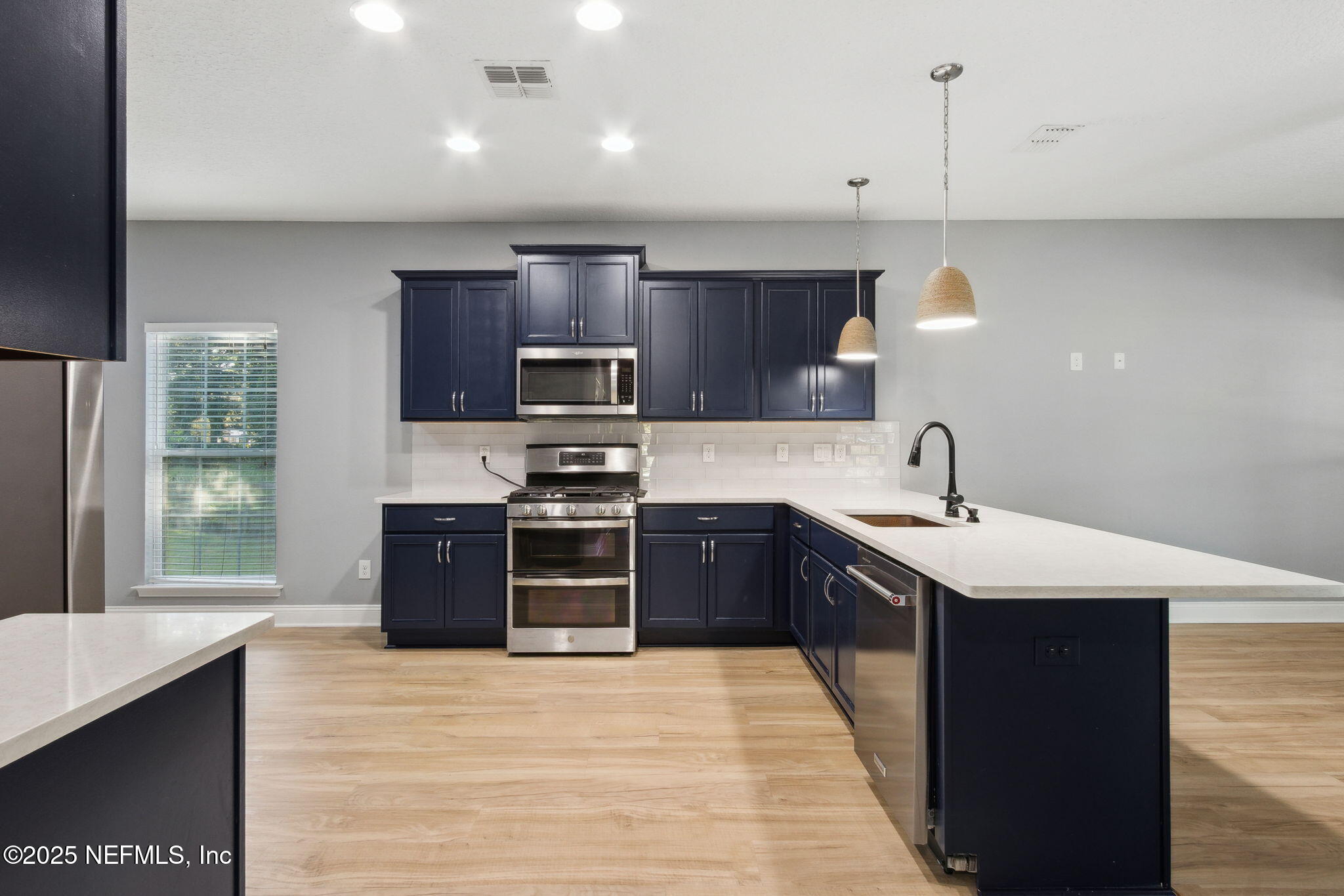16199 Shellcracker Road Jacksonville, FL 32226 - Photo 8 of 40 a kitchen with stainless steel appliances kitchen island granite countertop a refrigerator stove top oven and sink