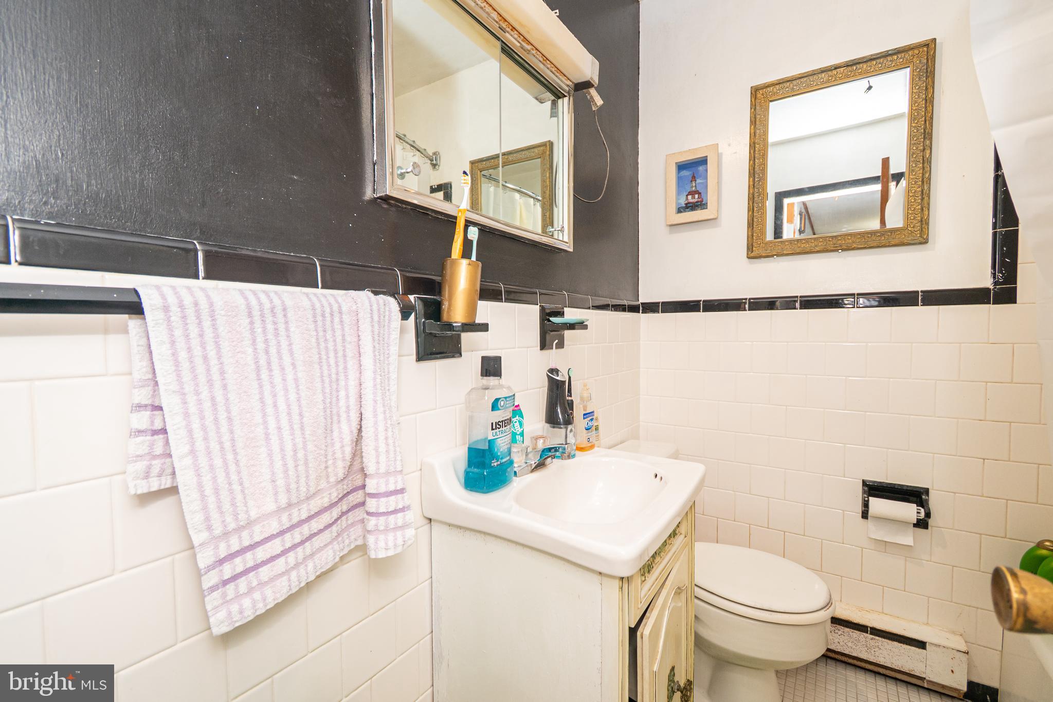 16308 Brandywine Road Brandywine, MD 20613 - Photo 21 of 27 a bathroom with a sink a toilet and a mirror