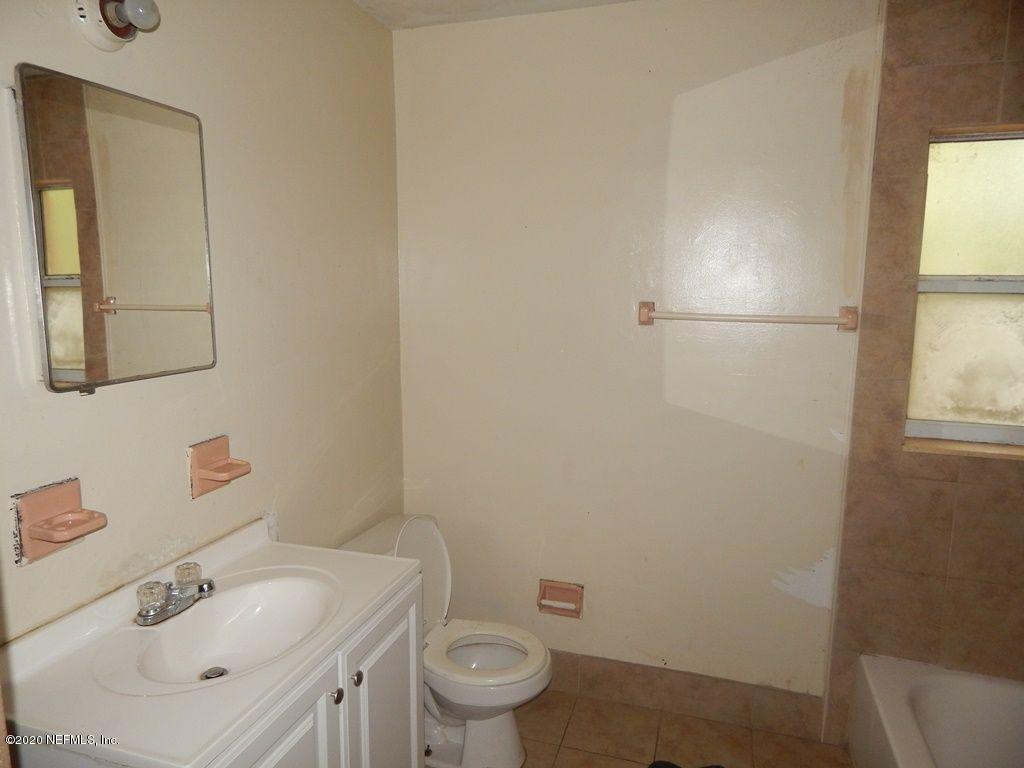 7514 Melvin Road Jacksonville, FL 32210 - Photo 5 of 7 a bathroom with a sink toilet and vanity