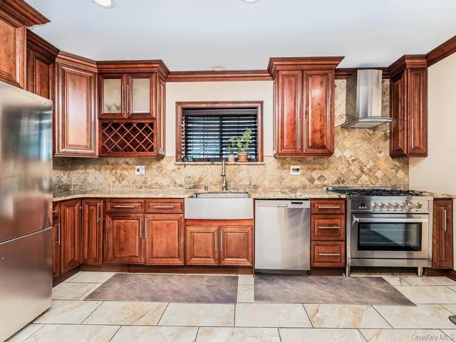 a kitchen with stainless steel appliances granite countertop a stove sink and cabinets
