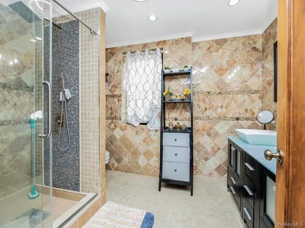 a bathroom with a shower and a sink a mirror