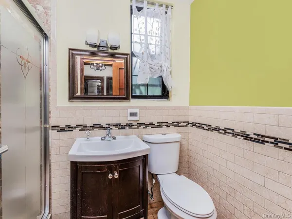 a bathroom with a sink a toilet and mirror