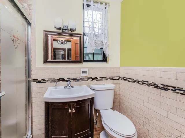 a bathroom with a sink a toilet and mirror