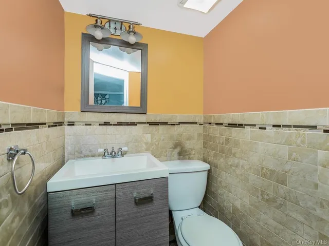 a bathroom with a sink a toilet and mirror