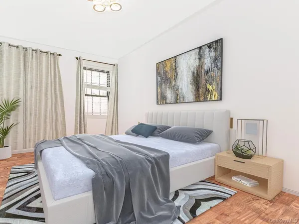a bedroom with a bed and a painting on the wall