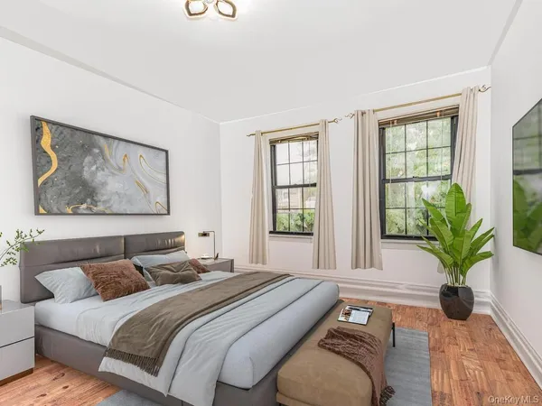 a spacious bedroom with a large bed and a potted plant