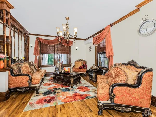 a living room with furniture and a chandelier