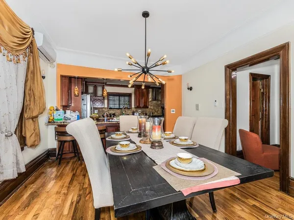 a dining room with furniture a rug and wooden floor