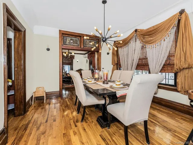 a view of a dining room with furniture wooden floor and a chandelier