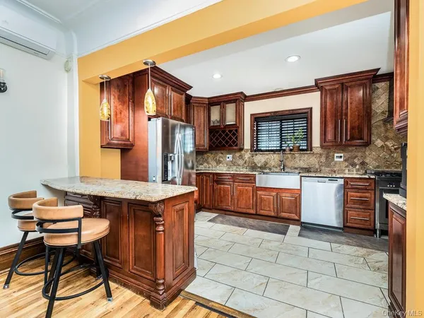 a kitchen with a stove a sink cabinets and wooden floor