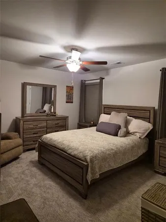 a bedroom with furniture and a mirror