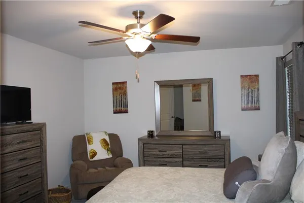 a bedroom with a bed and a television