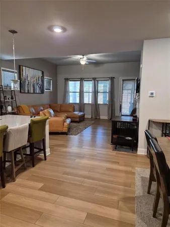 a living room with furniture and wooden floor