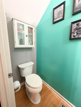a bathroom with a toilet and a window