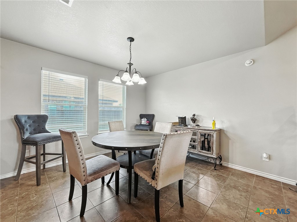 2701 Settlement Road Copperas Cove, TX 76522 - Photo 12 of 18 a view of a dining room with furniture a chandelier and wooden floor