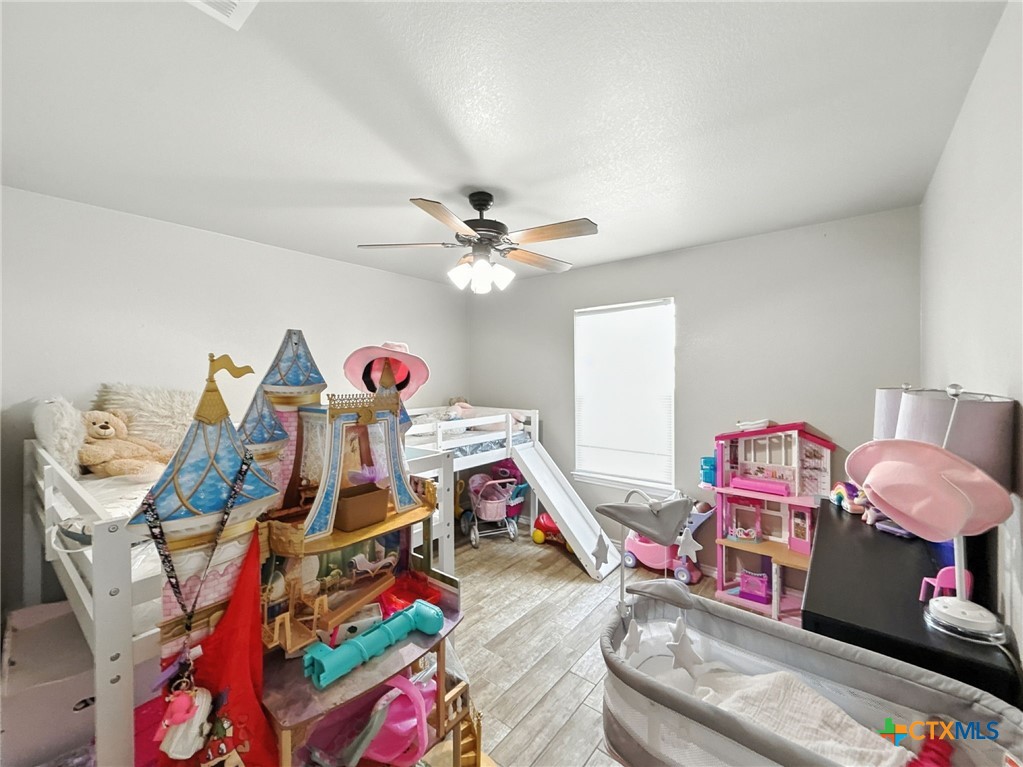 2701 Settlement Road Copperas Cove, TX 76522 - Photo 14 of 18 a bed room with a bed and a wooden floor