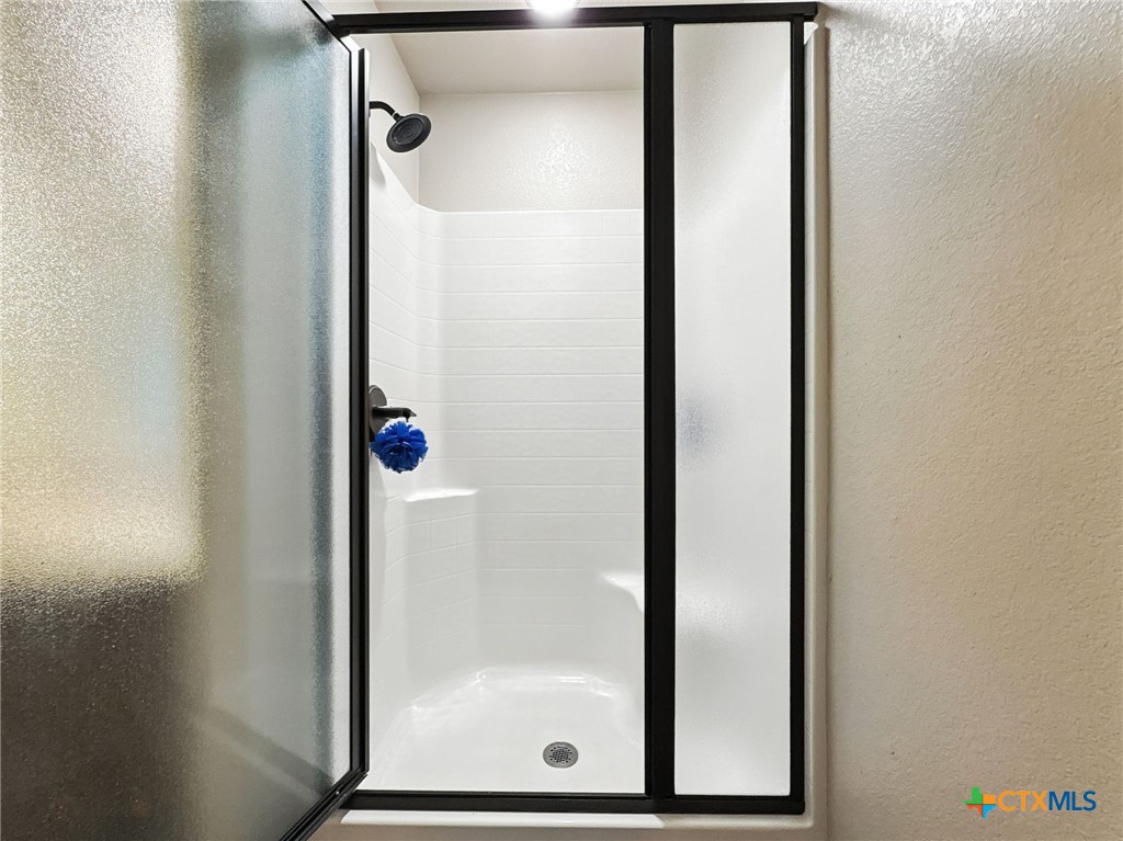 2701 Settlement Road Copperas Cove, TX 76522 - Photo 6 of 18 a bathroom with a glass shower door