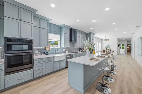 a kitchen with a sink stainless steel appliances and cabinets