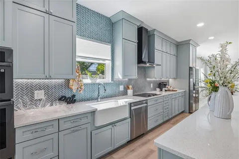 a kitchen with a sink stove and cabinets