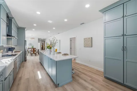 a view of kitchen with sink and refrigerator