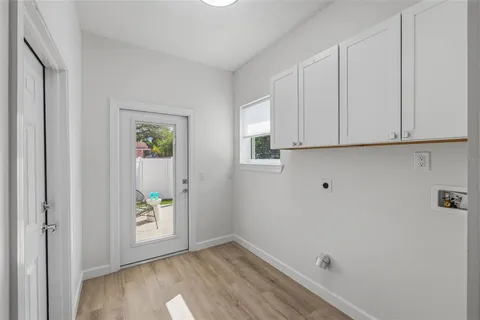 a view of an empty room and room with wooden floor