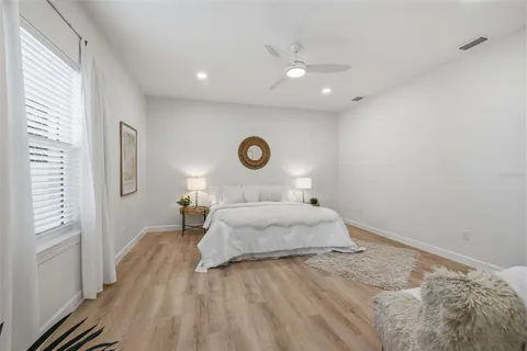 a bedroom with a bed and a lamp