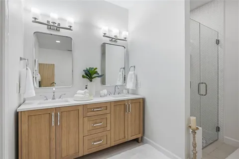 a bathroom with a double vanity sink and mirror