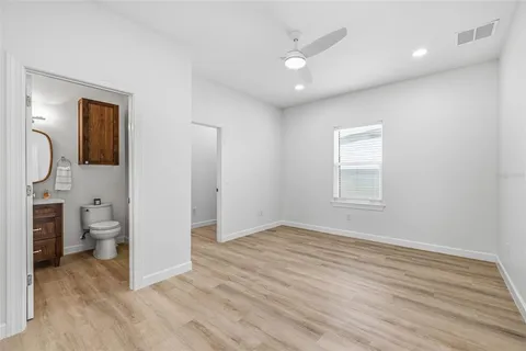 a view of a room with wooden floor and cabinet