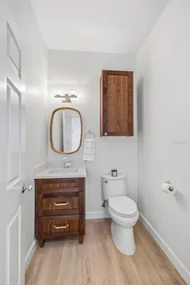 a bathroom with a toilet a sink and a mirror